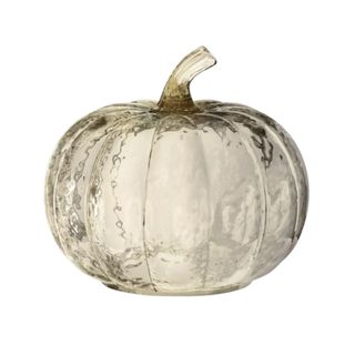 A champagne colored glass pumpkin decoration