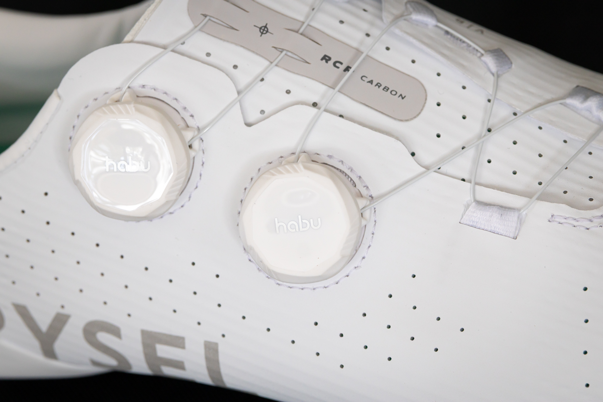 close up of the lace dials on a white road shoe
