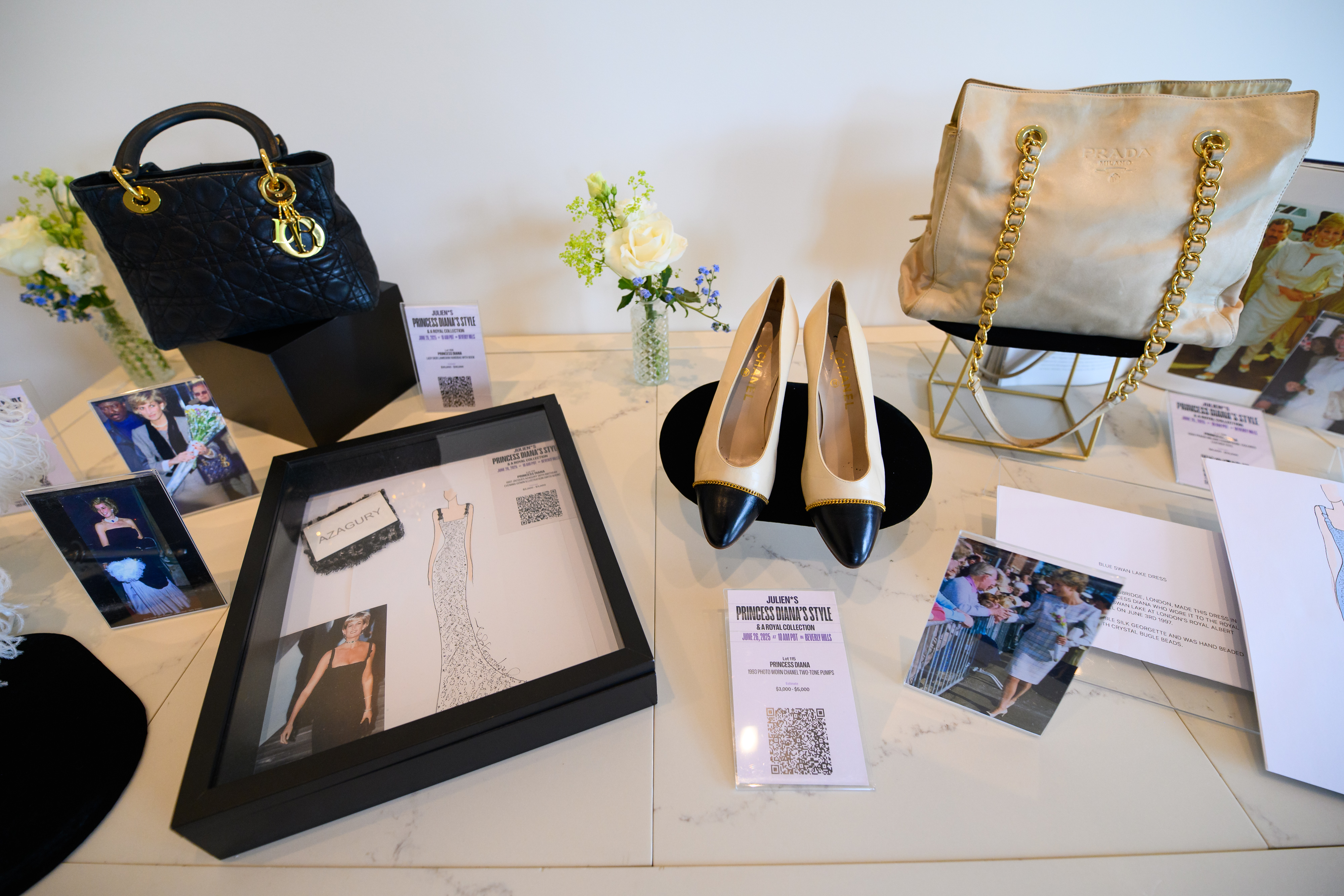 Princess Diana's shoes and purses on a display table for a 2025 fashion auction