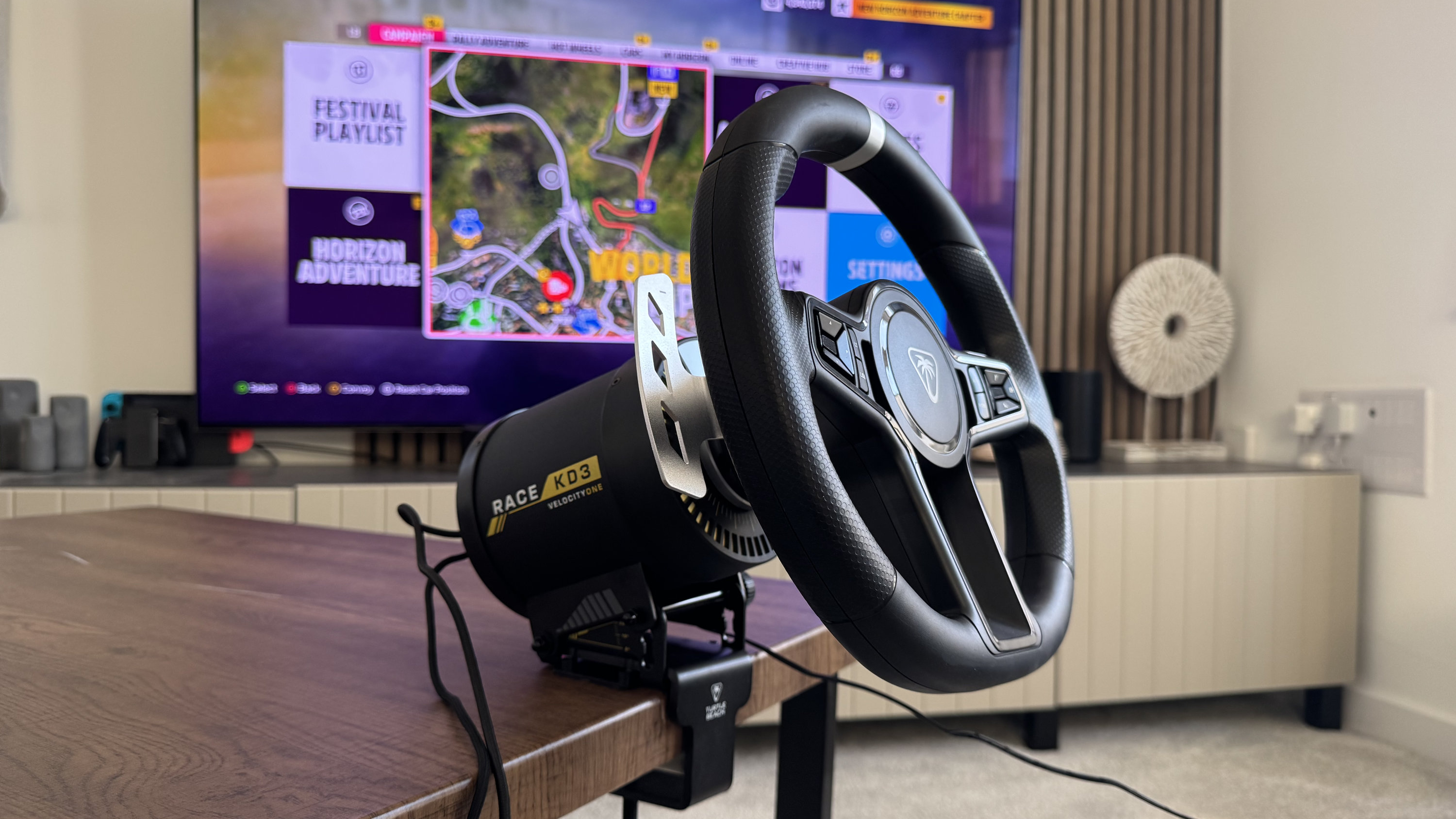 The Turtle Beach VelocityOne Race KD3 round wheel mounted to a coffee table