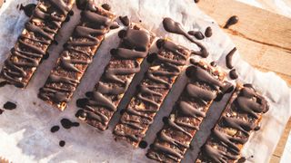 Several bars made of oats and fibrous foods, drizzled with chocolate