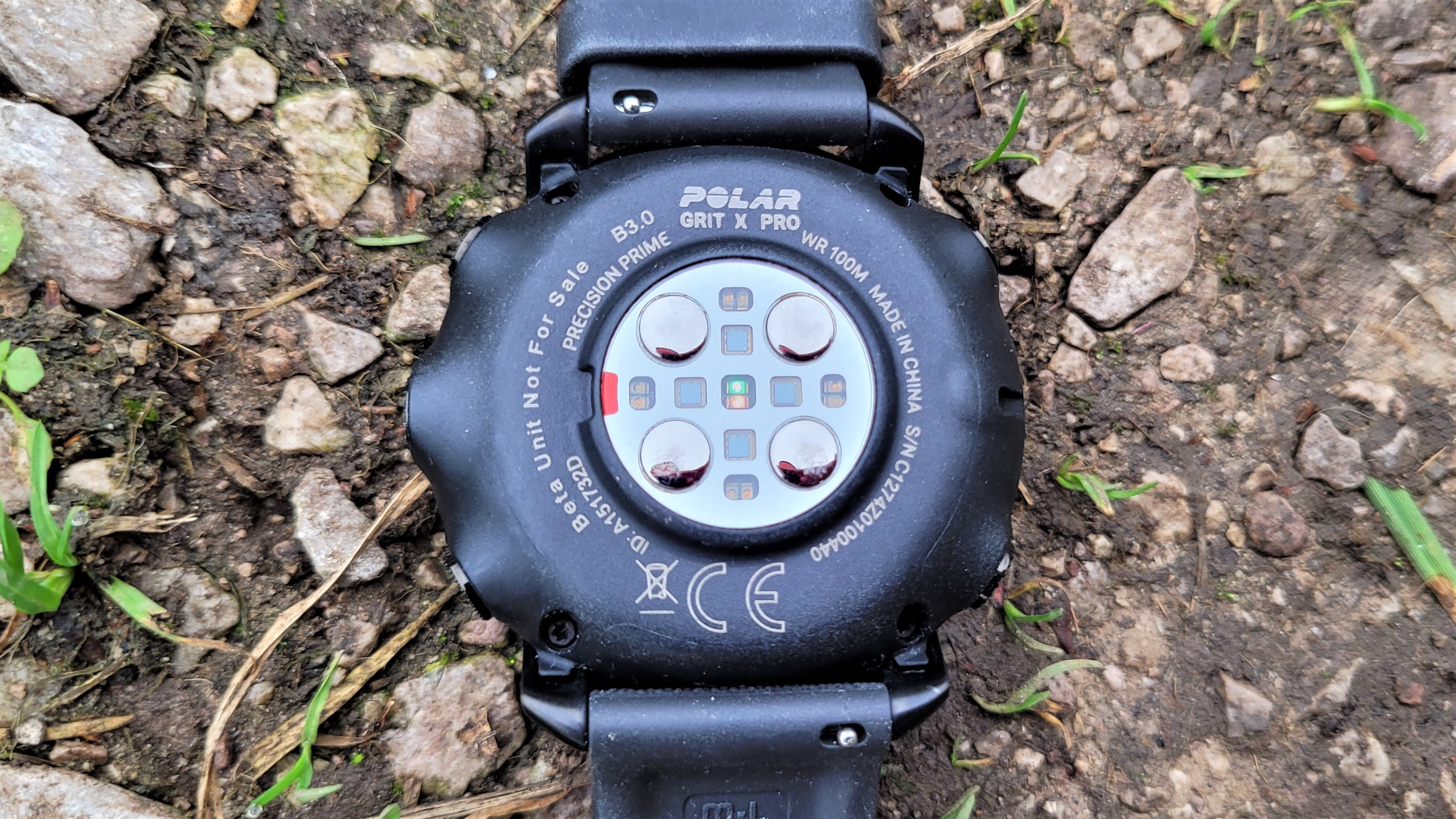 Rear of the Polar Grit X Pro, showing electrical contacts and optical heart rate sensor