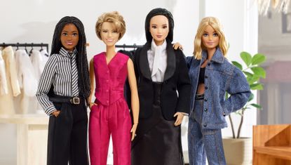 four barbie dolls dressed in miniature versions of kallmeyer suiting