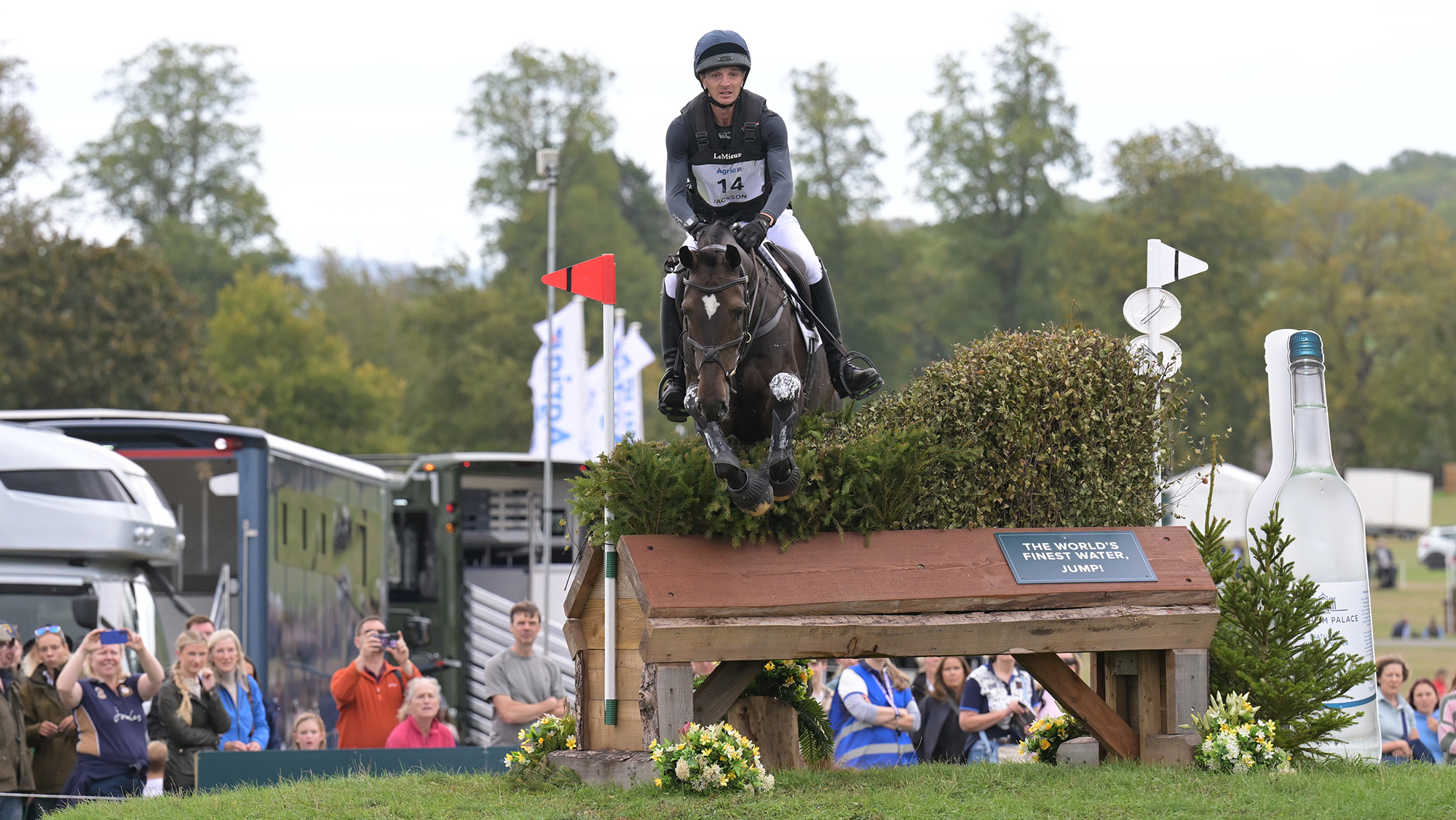 Tom Jackson, a rider in a dark top, rides dark bay horse Brookfield William over a brush fence at Blenheim Horse Trials 2026