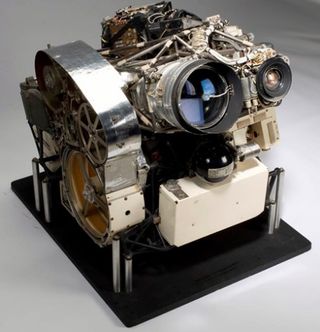 The Lunar Orbiter's onboard camera contained dual lenses that took photos simultaneously. One lens took wide-angle images of the moon at medium resolution. A second telephoto lens took high-resolution images in greater detail.