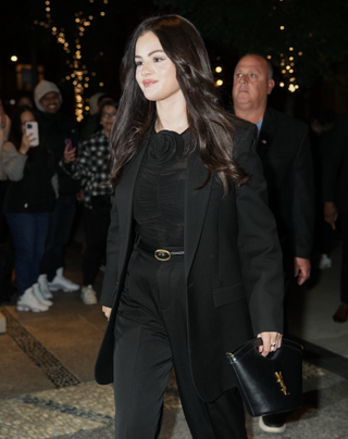 Selena Gomez is seen arriving at Crosby Hotel on October 16, 2024 in New York, New York wearing a black suit and her favorite YSL Celia bag