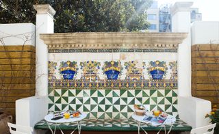 Outdoor terrace seating with mosaic decoration