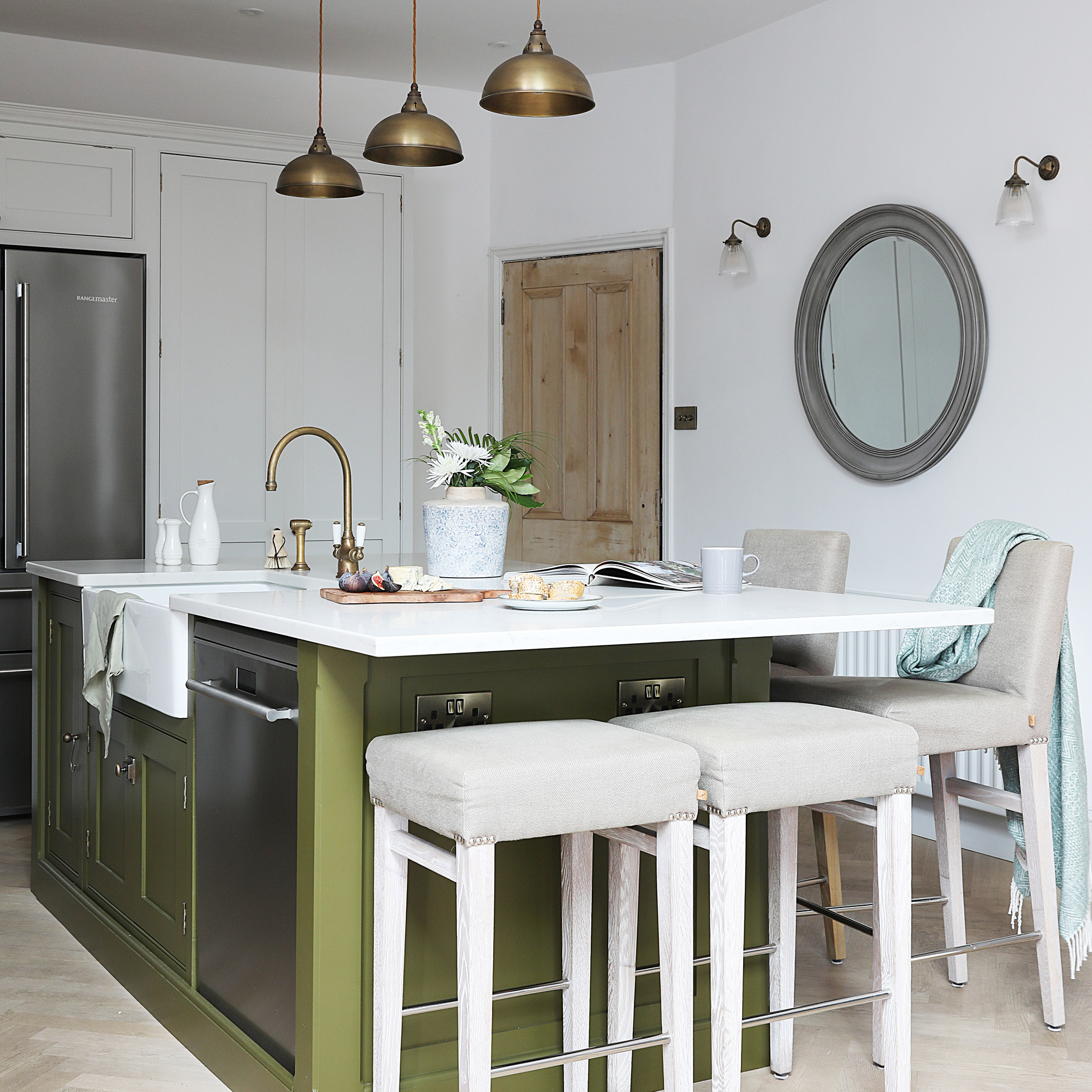 IDH315.house_barrett kitchen-diner in neutral extension with white walls with green kitchen island with brass pendant lights and bar stools