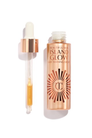 A bottle of Charlotte Tilbury Beautiful Skin Island Grow tanning drops set against a white background.