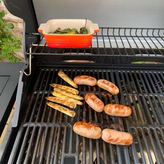 Baby corn and sausages on a grill