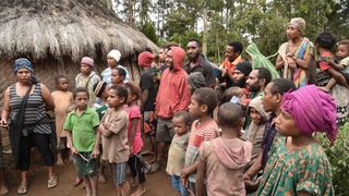 This photo taken on November 20, 2018 shows neighbours gathering near the home of 55-year-old mother-of-two Rachel in the Tsak Valley in the Highlands of Papua New Guinea after she talked to AFP about when in April 2017, she was accused of sorcery and tortured with hot machetes, spades and rods for a full day by people she knew. A spate of brutal witch hunts has plunged parts of Papua New Guinea's highlands into a state of terror, as fearful tribes blame dark forces for their rapidly changing world.