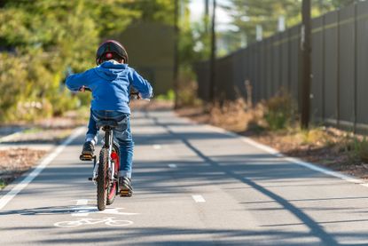 A child rides a bike.