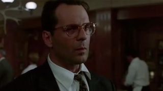 Bruce Willis wearing glasses and looking suspicious in The Bonfire Of The Vanities