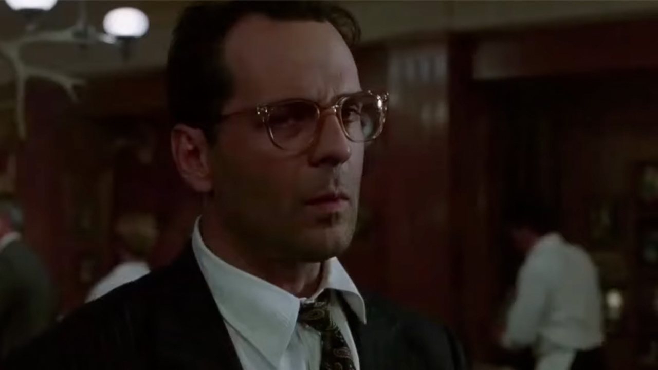 Bruce Willis wearing glasses and looking suspicious in The Bonfire Of The Vanities
