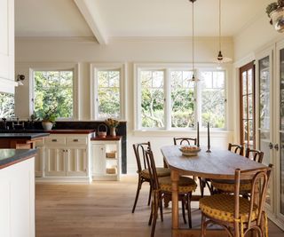 kitchen dining space with vintage table and chairs and soft neutral colors and wooden floors