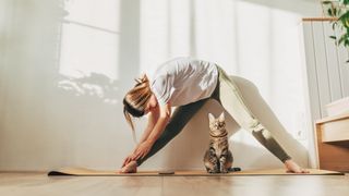lady doing yoga with cat