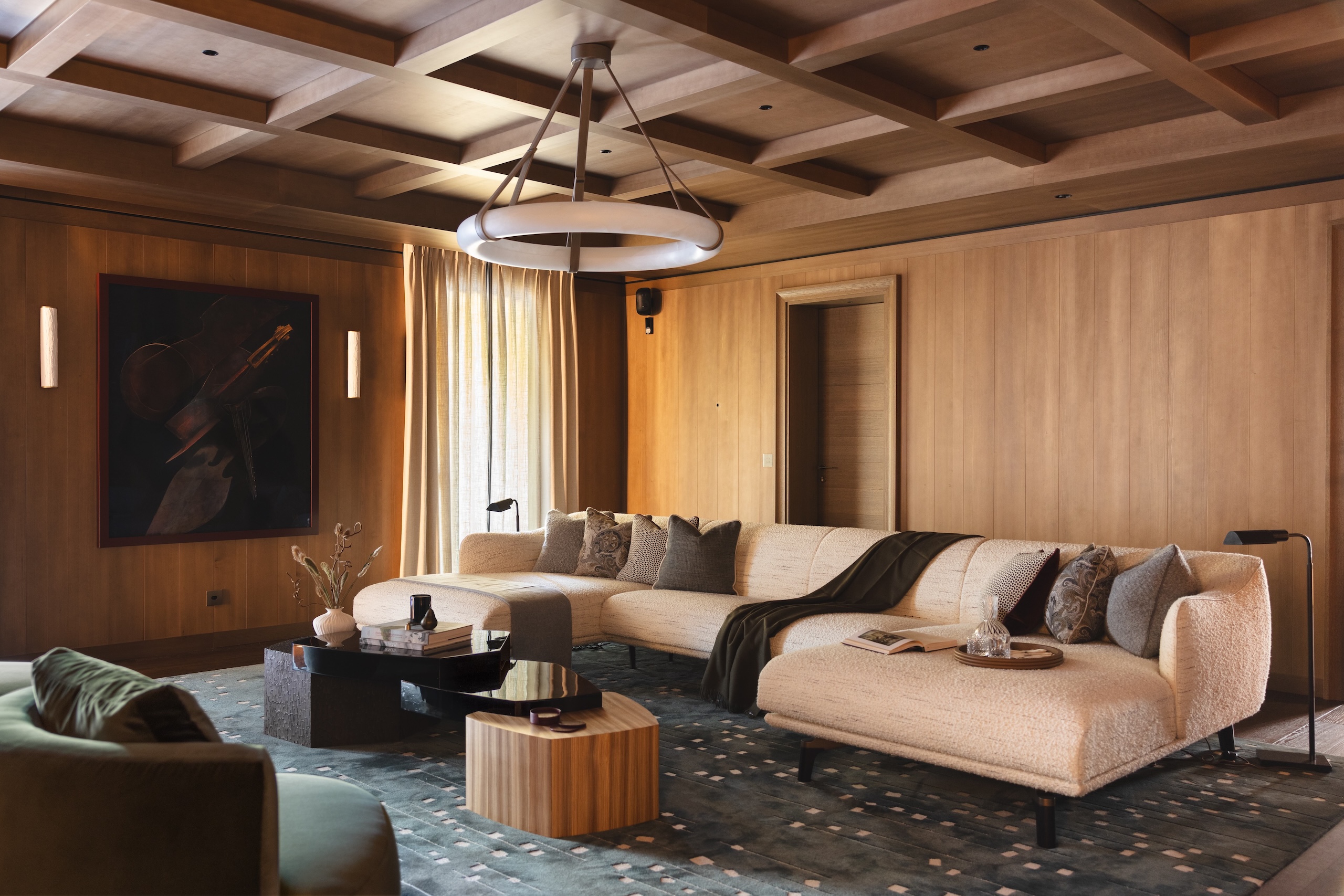 A contemporary living space with a warm oatmeal boucl&amp;eacute; six-seater sofa with arms and chaise elements