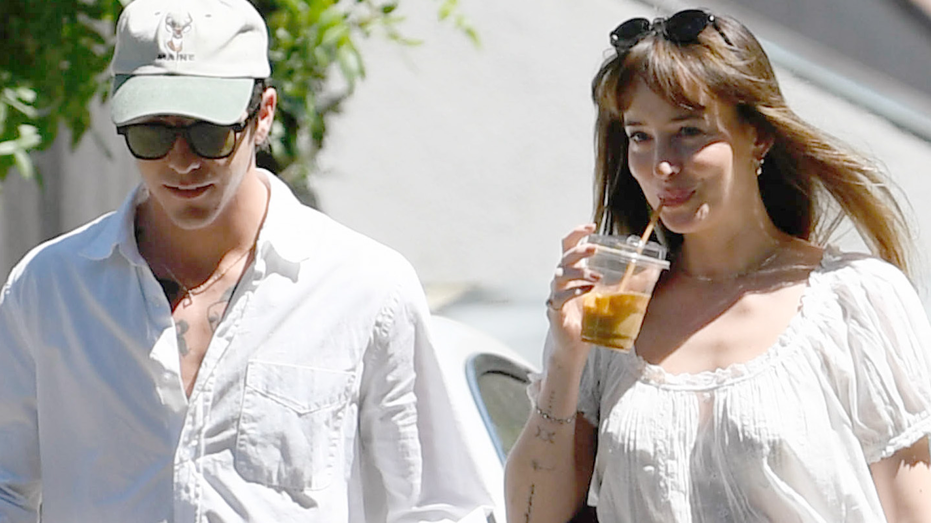 Dakota Johnson went out with rumored boyfriend Role Model dressed in a boho shirt trend, jeans, ballet flats, and a burgundy The Row bag