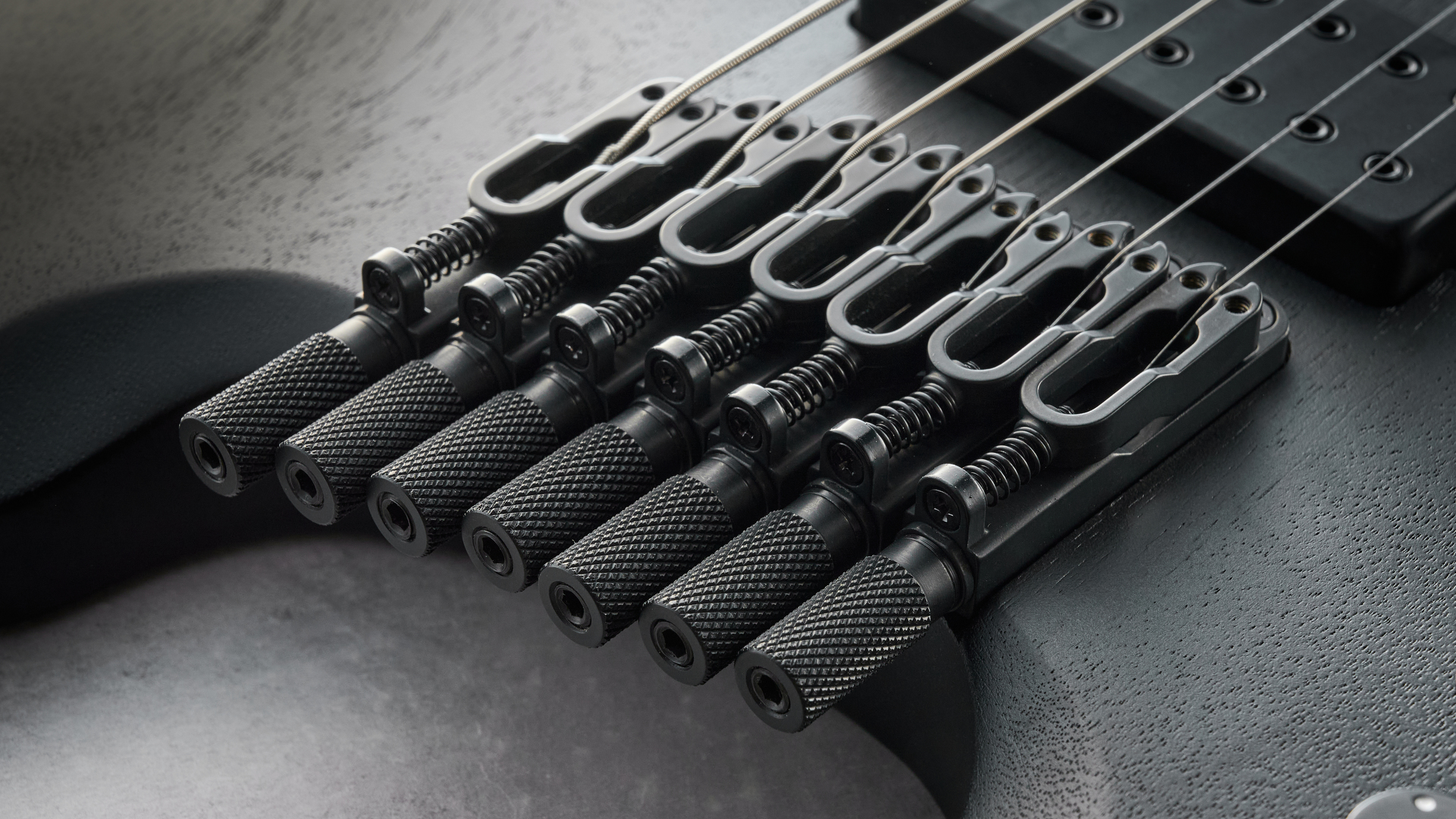 Ibanez QX527B headless guitar shot on grey surface