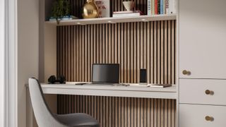 close up of built in office desk with lighting in shelf above desk and wooden slatted wall behind