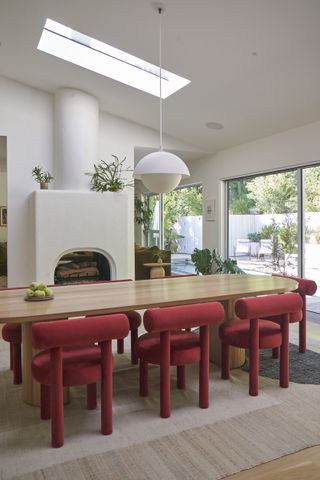 a dining room with red chairs