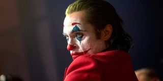 Joaquin Phoenix shows side profile in clown makeup in Joker