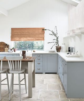 pale blue kitchen with white walls