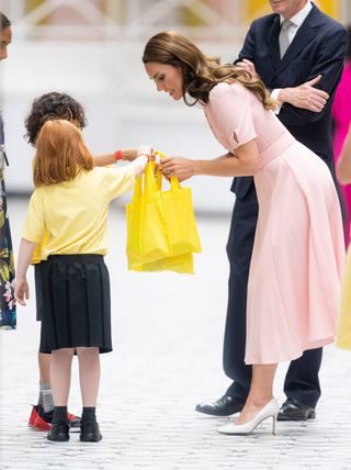 Kate Middleton interacts with children on a royal engagement