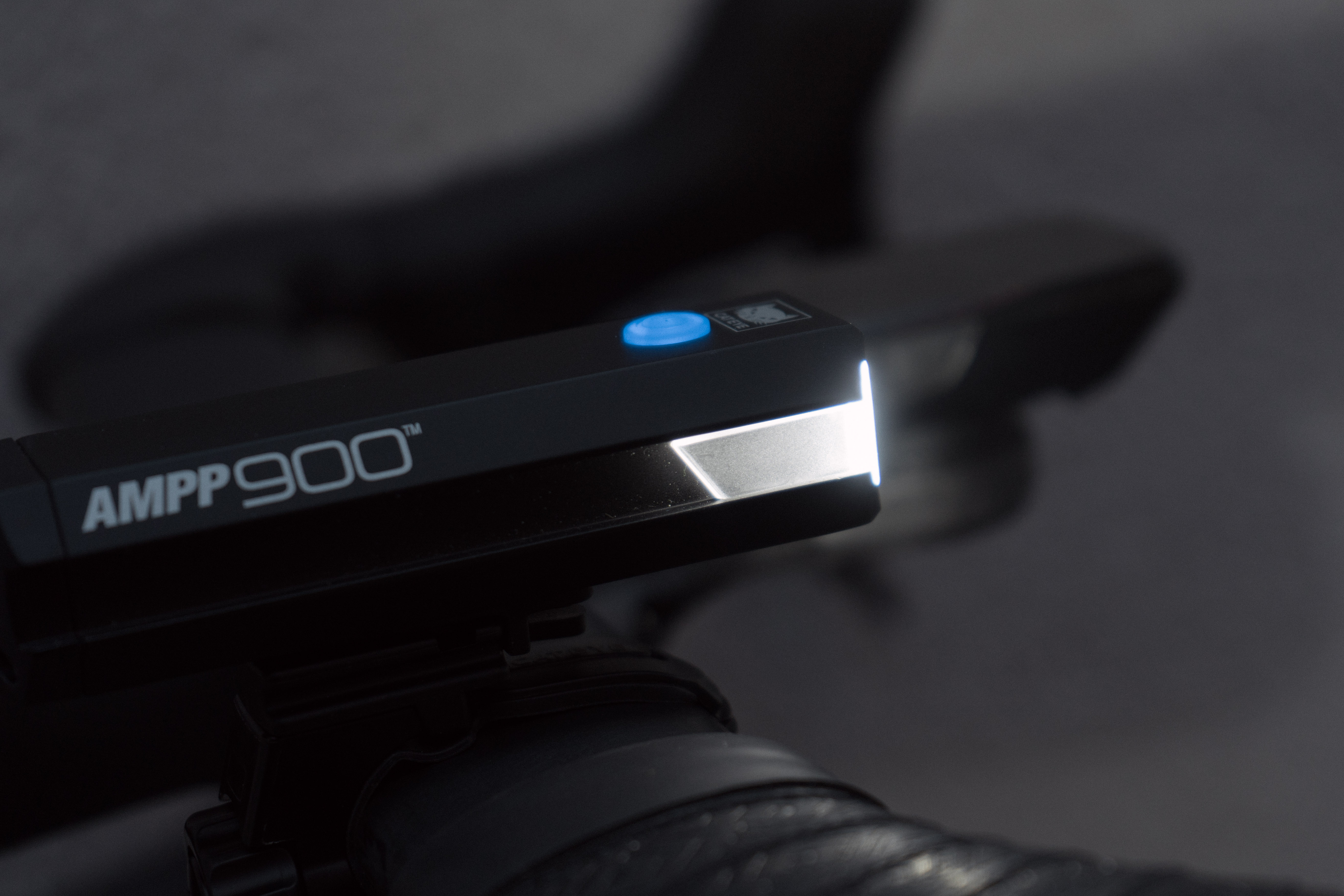 A bike light viewed from the side showing illuminated panels for added side visibility