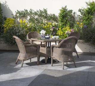 Outdoor table and chairs in a narrow garden