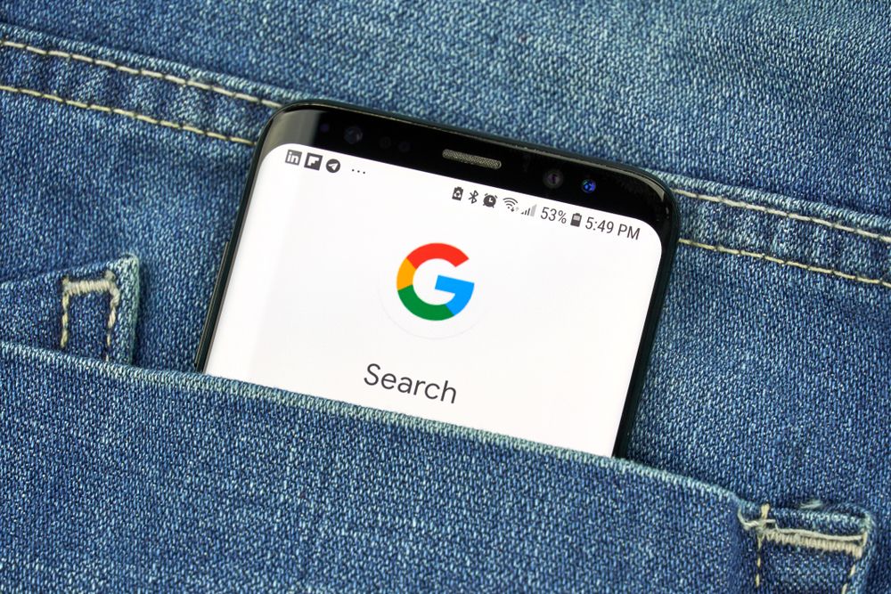 Google search on a smartphone poking out of a pocket 