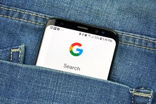 Google search on a smartphone poking out of a pocket 