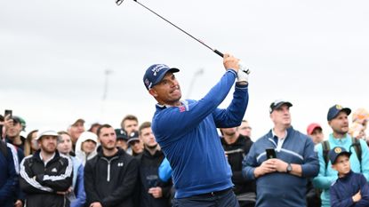Padraig Harrington hits an iron shot in front of crowds at The Open