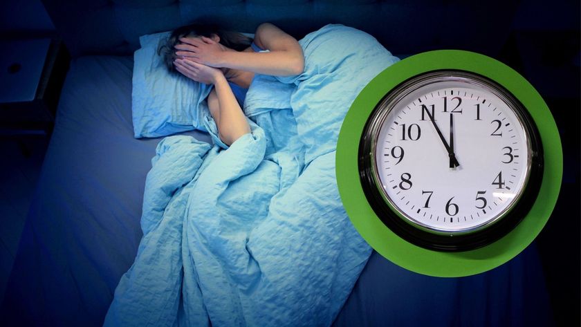 A woman lying in bed with her hands over her eyes and an image of a clock showing the time of 11.55pm