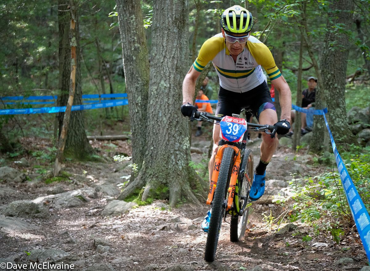 Dan McConnell (DanAndBec) riding a rock garden with one lap remaining