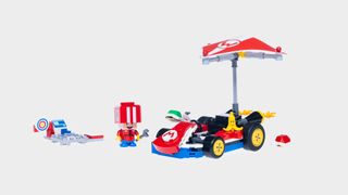 Lego kart, accessories, and pitstop Toad against a plain background