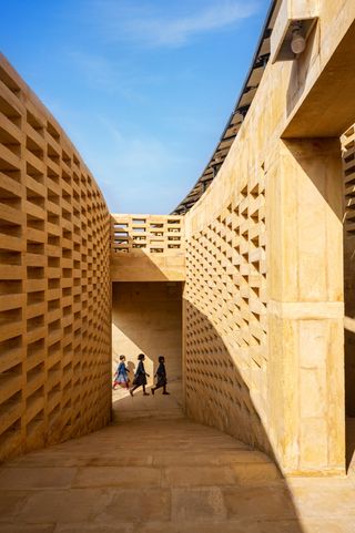 view through the permeable brick corridors of the sustainable girl's school in India by Diana Kellogg