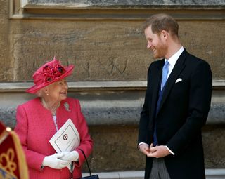 Queen Elizabeth II speaks with Prince Harry, Duke of Sussex as they leave after the wedding of Lady Gabriella Windsor to Thomas Kingston