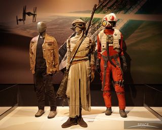 Costumes from the upcoming movie "Star Wars: The Force Awakens": (l to r) Finn, Rey, Poe Dameron.