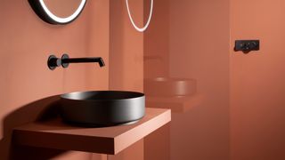 coral bathroom with black taps and basin as current bathroom trend 2022