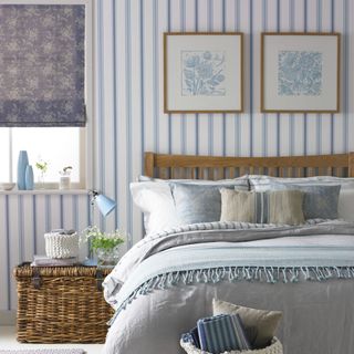 Bedroom with bed and striped wallpaper
