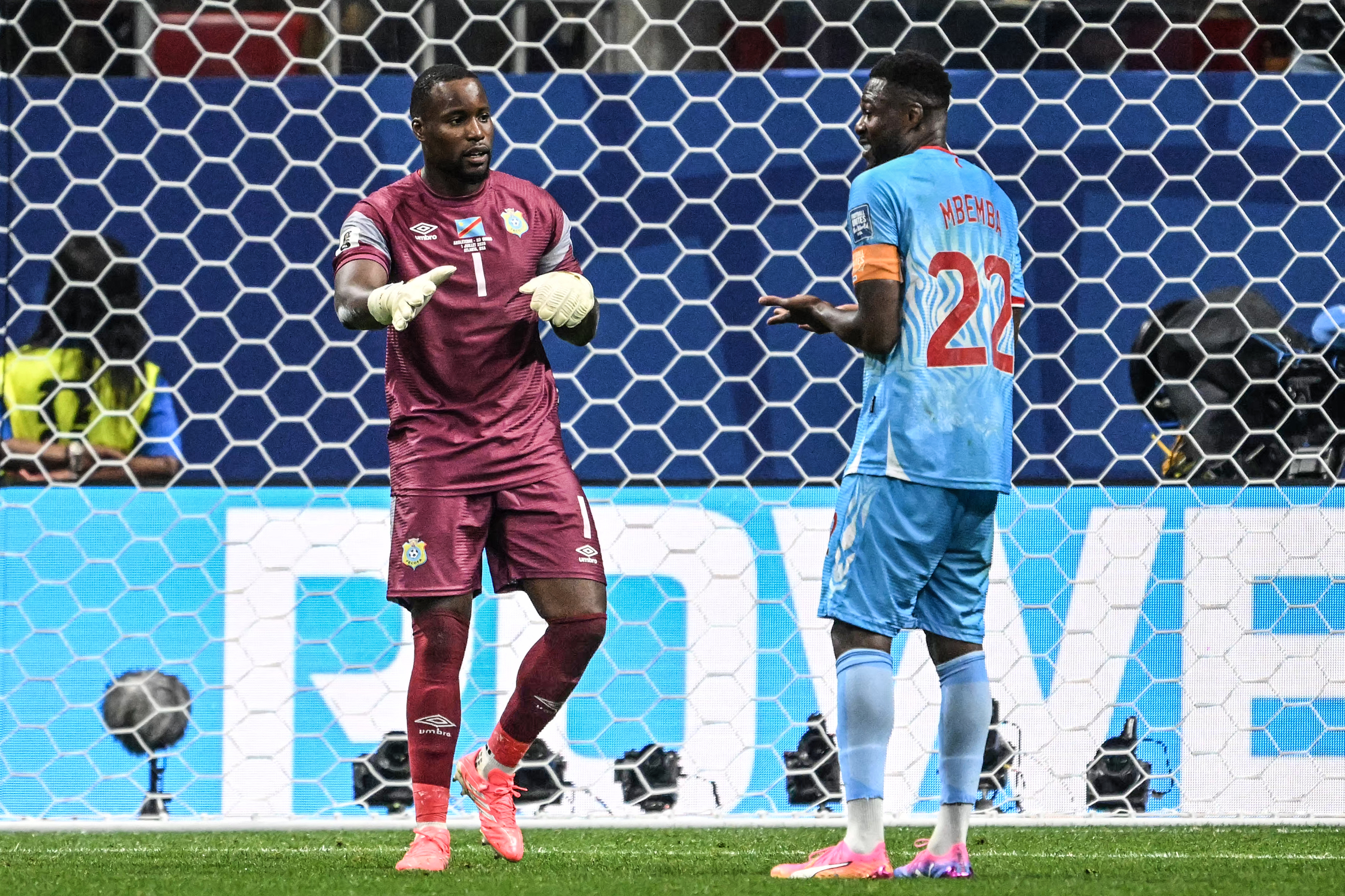 Lionel Mpasi Nzau gesturing to his defender.