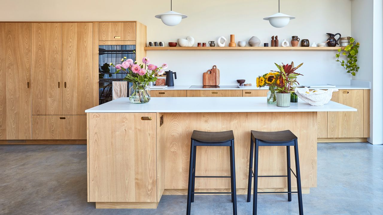 A contemporary, Scandi-style kitchen with pale wooden kitchen cabinets and kitchen island