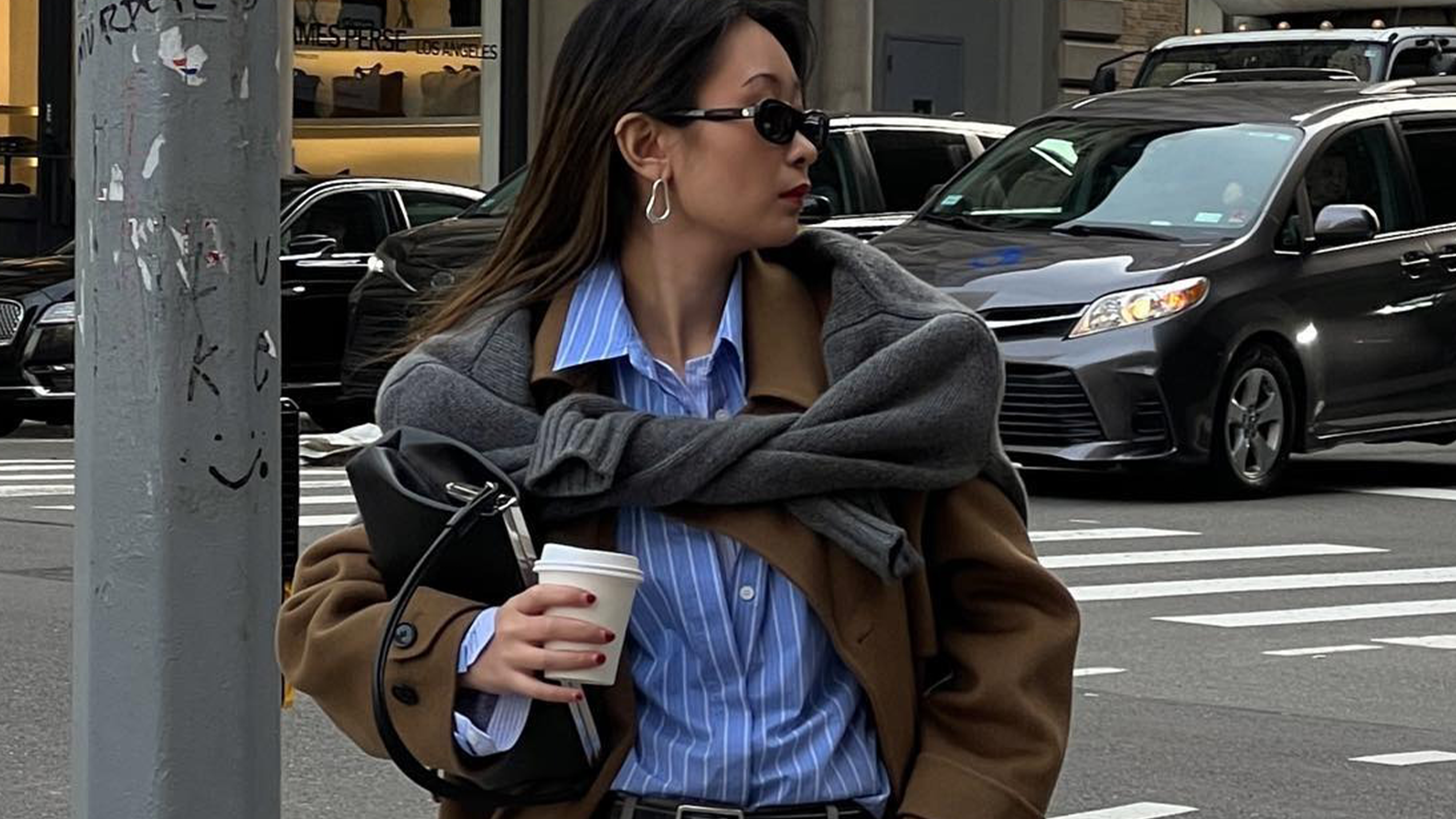 Woman wearing fall outfit featuring black ankle boots.