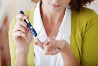 A woman checks her blood sugar levels.