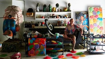 Ashley Bickerton in his studio in Bali, surrounded by sculptures and paintings