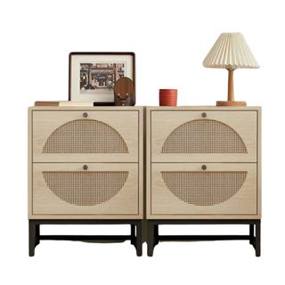 Two light brown nightstands with a photo frame and lamp on top