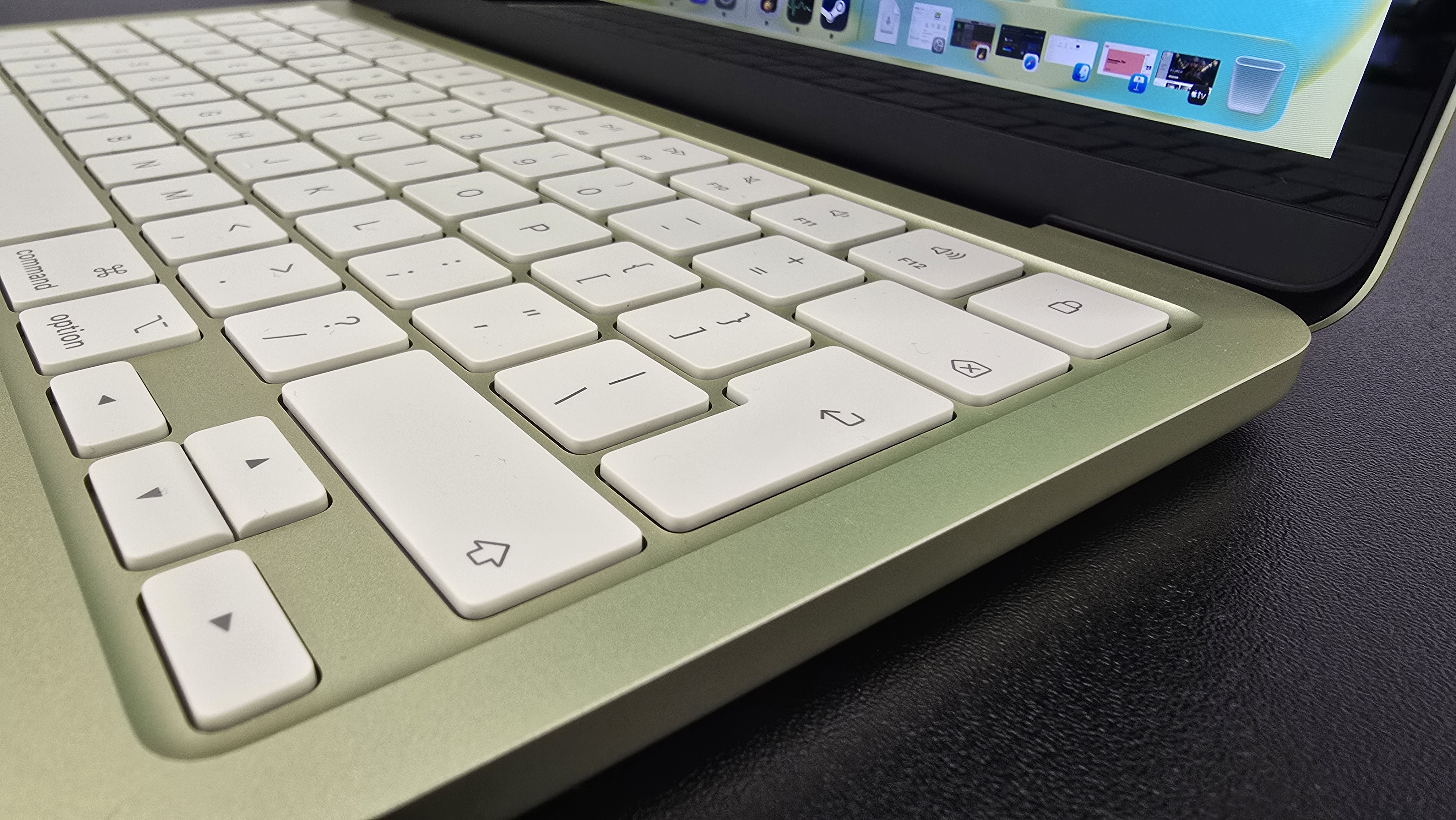 MacBook Neo laptop on a desk with plant in background