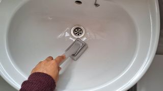 Cleaning sink with dish wand