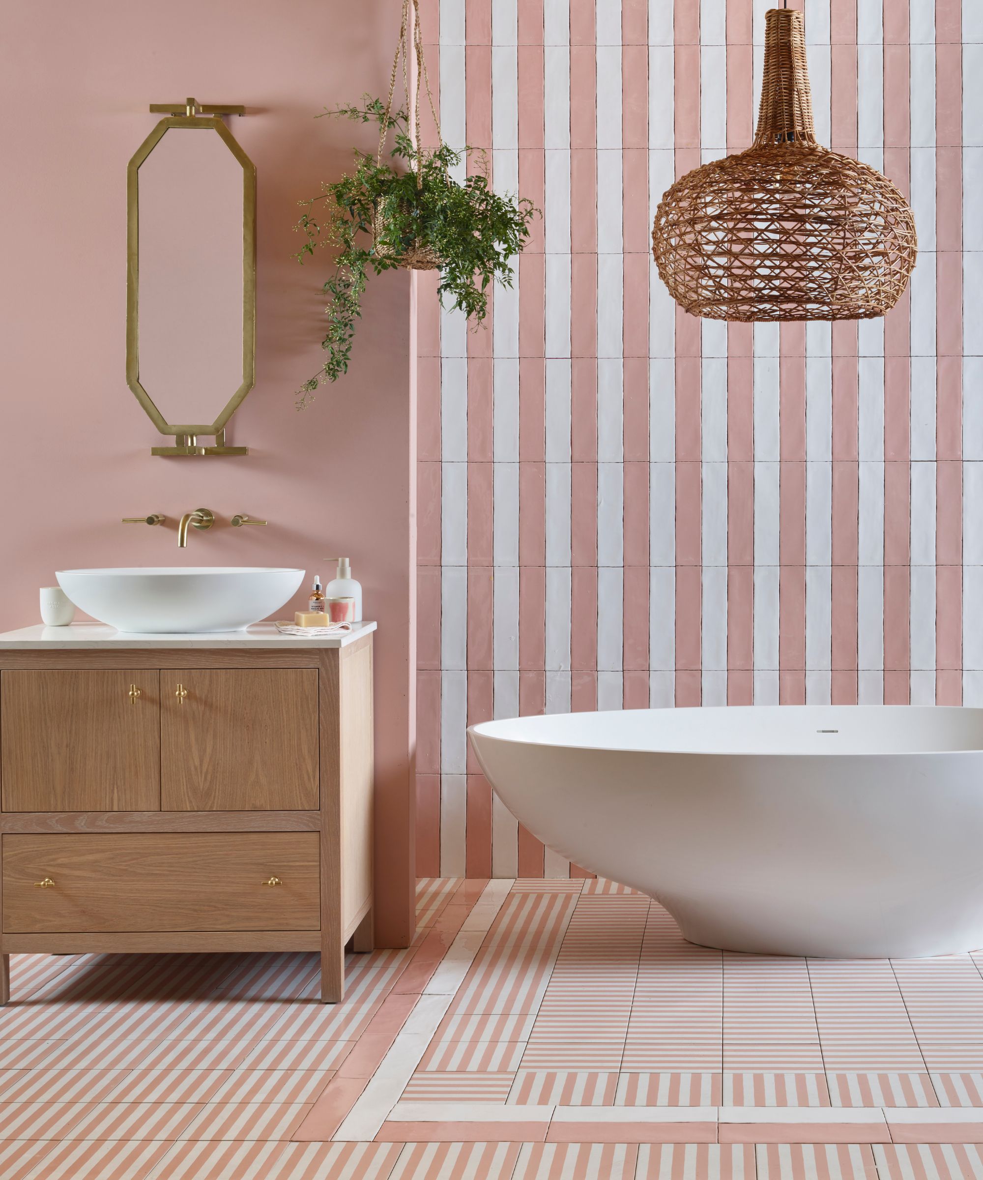 pink striped bathroom with freestanding tub